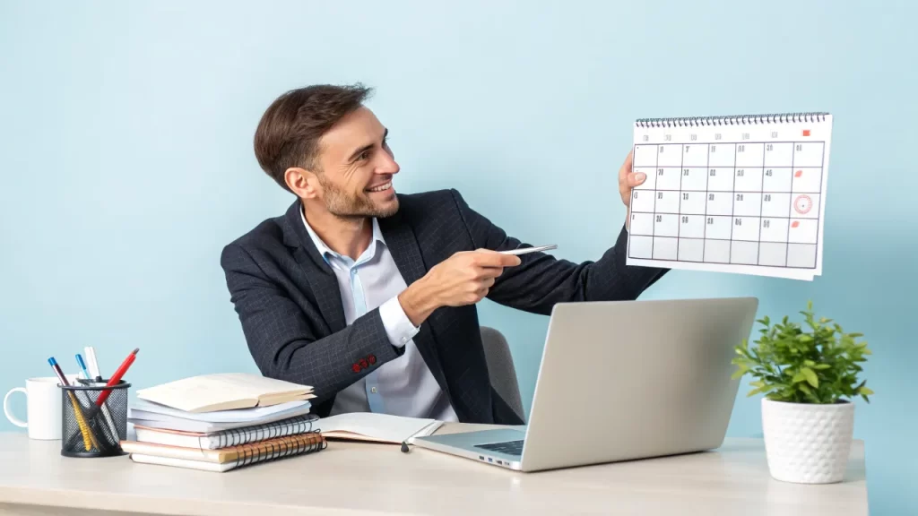 Man pointing at calendar, business coach concept.
